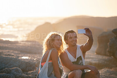 Buy stock photo happy couple taking photo using smartphone on beach sharing romantic vacation together