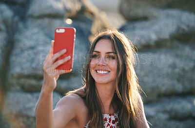 Buy stock photo Beautiful woman taking photo using smartphone on beach at sunset