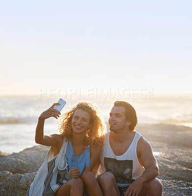 Buy stock photo happy couple taking photo using smartphone on beach sharing romantic vacation together