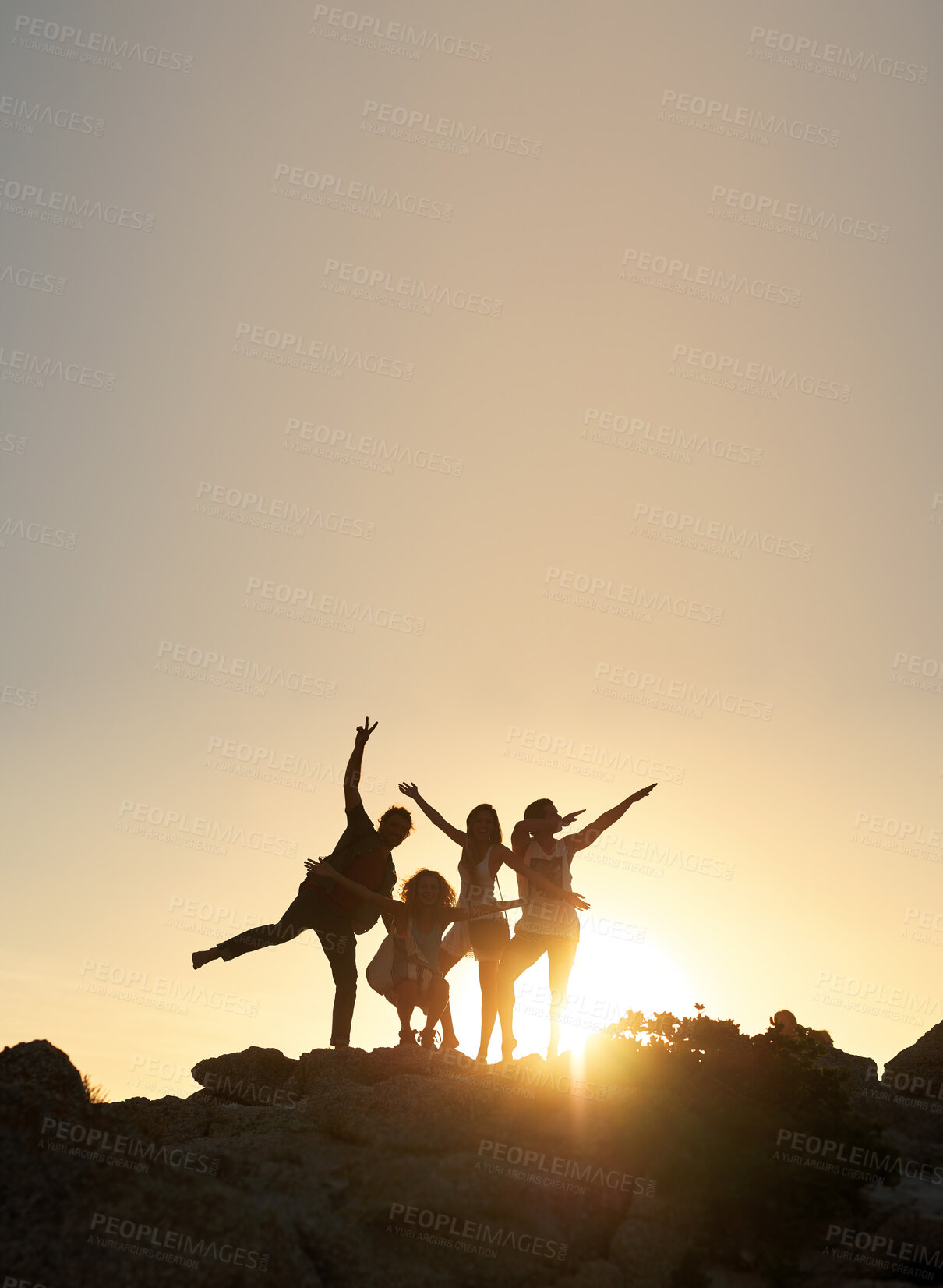 Buy stock photo Group of friends posing standing on rocks at sunset having fun summer vacation lifestyle celebrating friendship