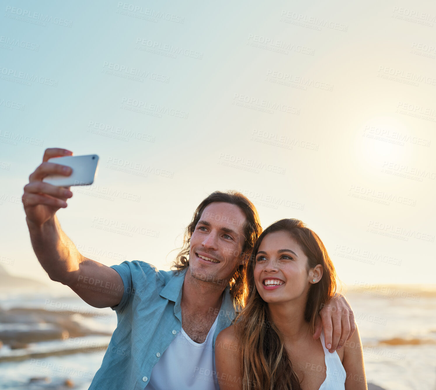 Buy stock photo happy couple taking photo using smartphone on beach sharing romantic vacation together