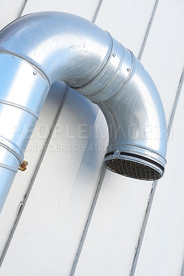 Buy stock photo Stainless steel ventilation duct and pipe on the side of an industrial and factory wall. Architectural design for ventilation and combustion gas regulation. Engineering structure for air distribution