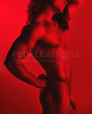 Buy stock photo Studio shot of a muscular young man posing nude against a red background