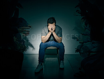 Buy stock photo One mixed race male suffering mental illness in asylum. Caucasian schizophrenic man experiencing depression while being surrounded by people on a stage theatre performance