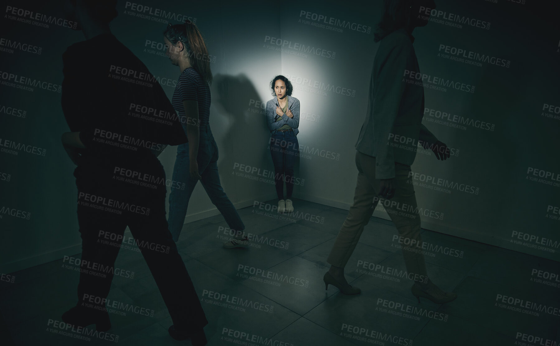 Buy stock photo One mixed race female suffering mental illness in asylum. Hispanic woman experiencing a panic attack while being surrounded by people inside. Rape and Abuse victim feeling alone