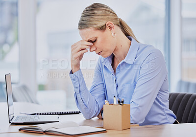Young frustrated caucasian business woman working at office desk suffering from chronic headaches while sitting in front of laptop. Female professional looking stressed and overworked
