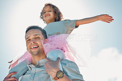 Buy stock photo Low Portrait view of a father carrying his daughter on his shoulders outdoors.