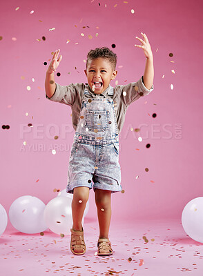 Buy stock photo A cute little mixed race boy  celebrating and winning against a pink copyspace background in a studio. African child looking excited at a gender reveal party with confetti and balloons