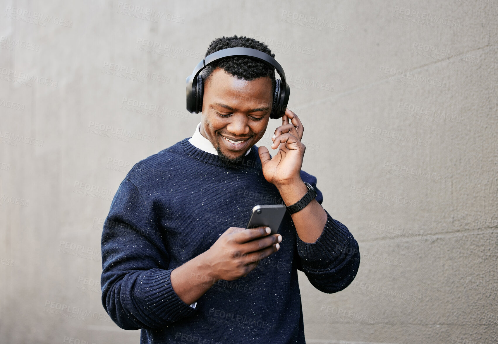 Buy stock photo Outdoor, black man and happy on smartphone with headphones for streaming music Uganda. Male person, employee and smile with browsing internet for social media, website and podcast for entertainment