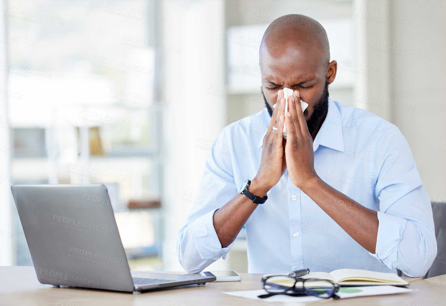 Buy stock photo Black man in office, blowing nose with allergies and sick while at work, professional person with virus and health problem. Businessman at desk with allergy, using tissue with disease and illness