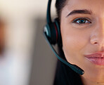 Closeup portrait of one young caucasian call centre telemarketing agent talking on headset while working in office. Face divided in half of friendly businesswoman operating helpdesk for customer service and sales support