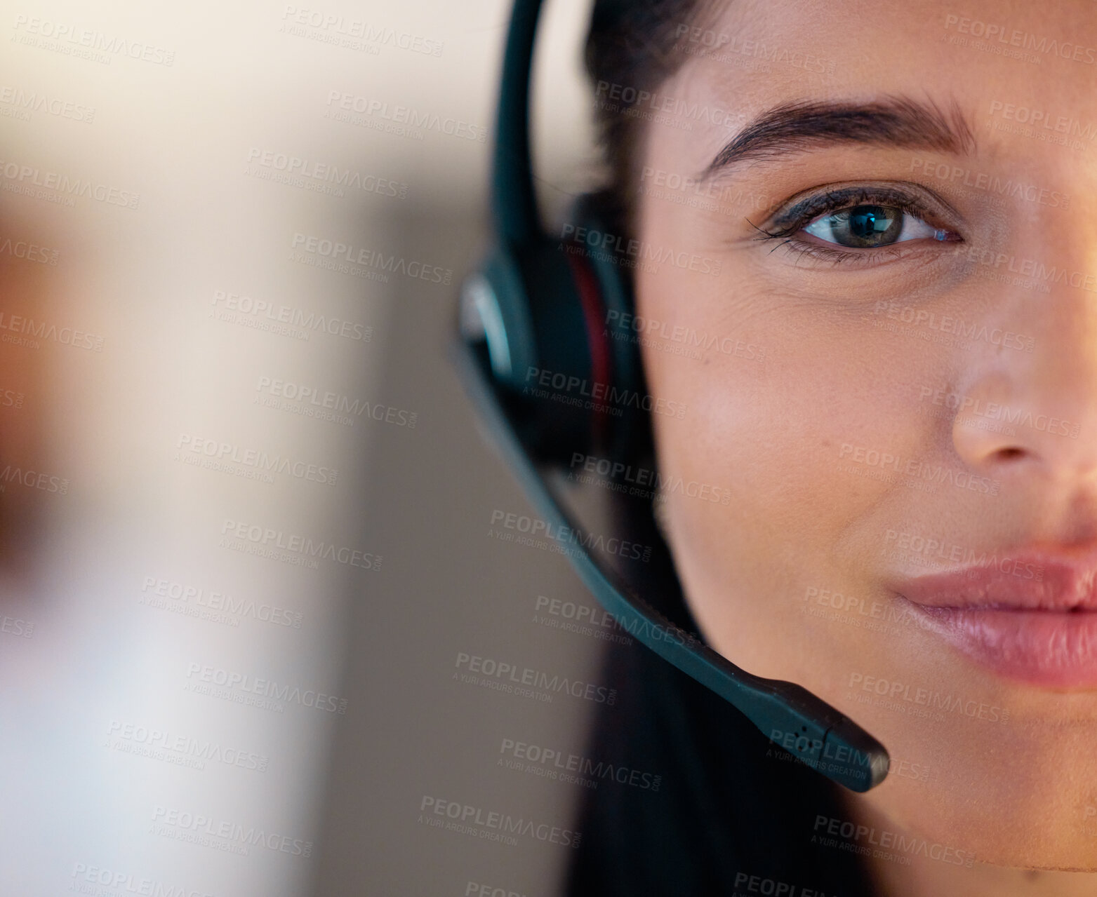 Buy stock photo Closeup portrait of one young caucasian call centre telemarketing agent talking on headset while working in office. Face divided in half of friendly businesswoman operating helpdesk for customer service and sales support