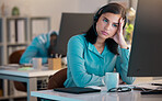 One stressed young caucasian call centre telemarketing agent looking bored with headache while working on computer in an office. Female consultant feeling overworked, tired and demotivated. Lazy employee slacking and struggling with difficult callers