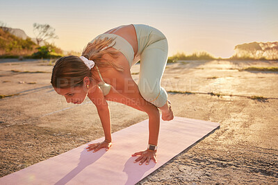 Buy stock photo Full length yoga woman holding crow pose in outdoor practice in remote nature. Beautiful caucasian person using mat, balancing on hands while stretching alone at sunset. Young, active, zen and serene