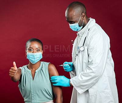 Buy stock photo African american covid vaccinated woman showing thumbs up sign and symbol. Black doctor giving vaccine to patient wearing surgical face mask. Endorsing corona needle injection from physician in studio