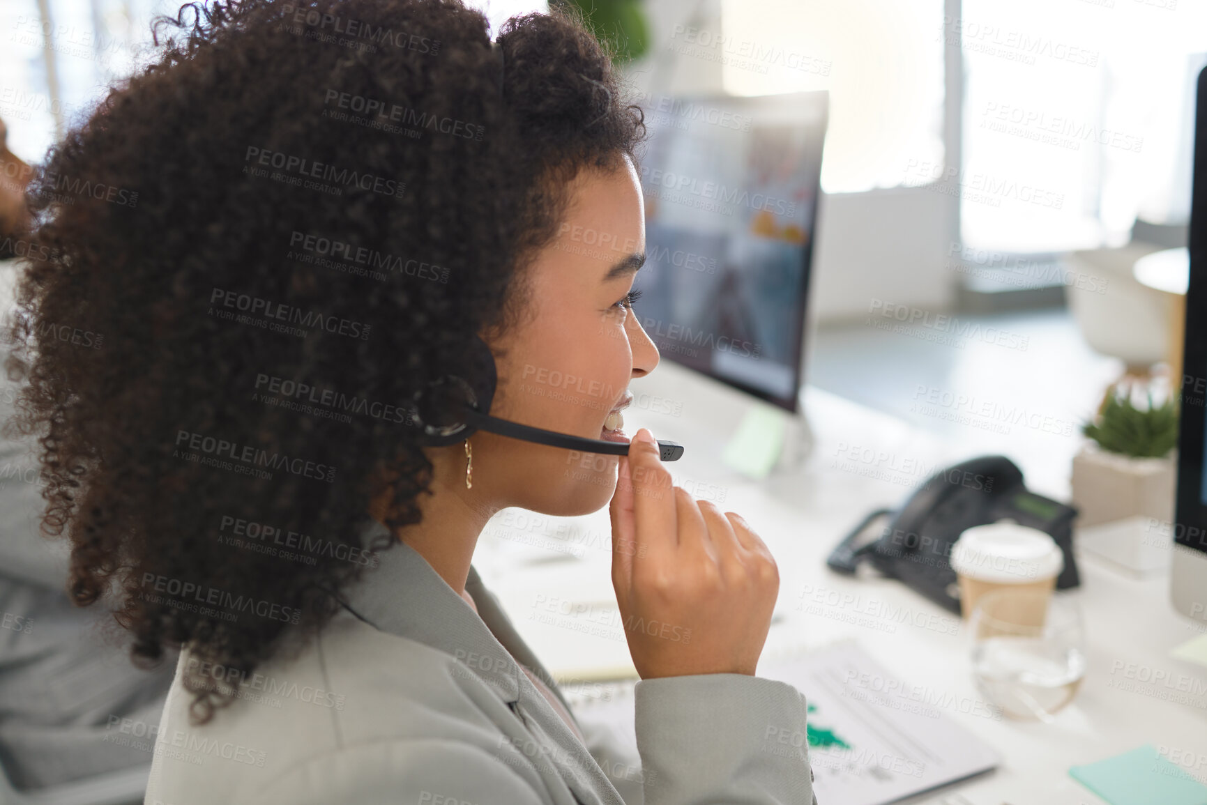 Buy stock photo Young cheerful mixed race female call center agent answering calls while wearing a headset at work. Hispanic businesswoman with a curly afro talking on a call at a desk in an office