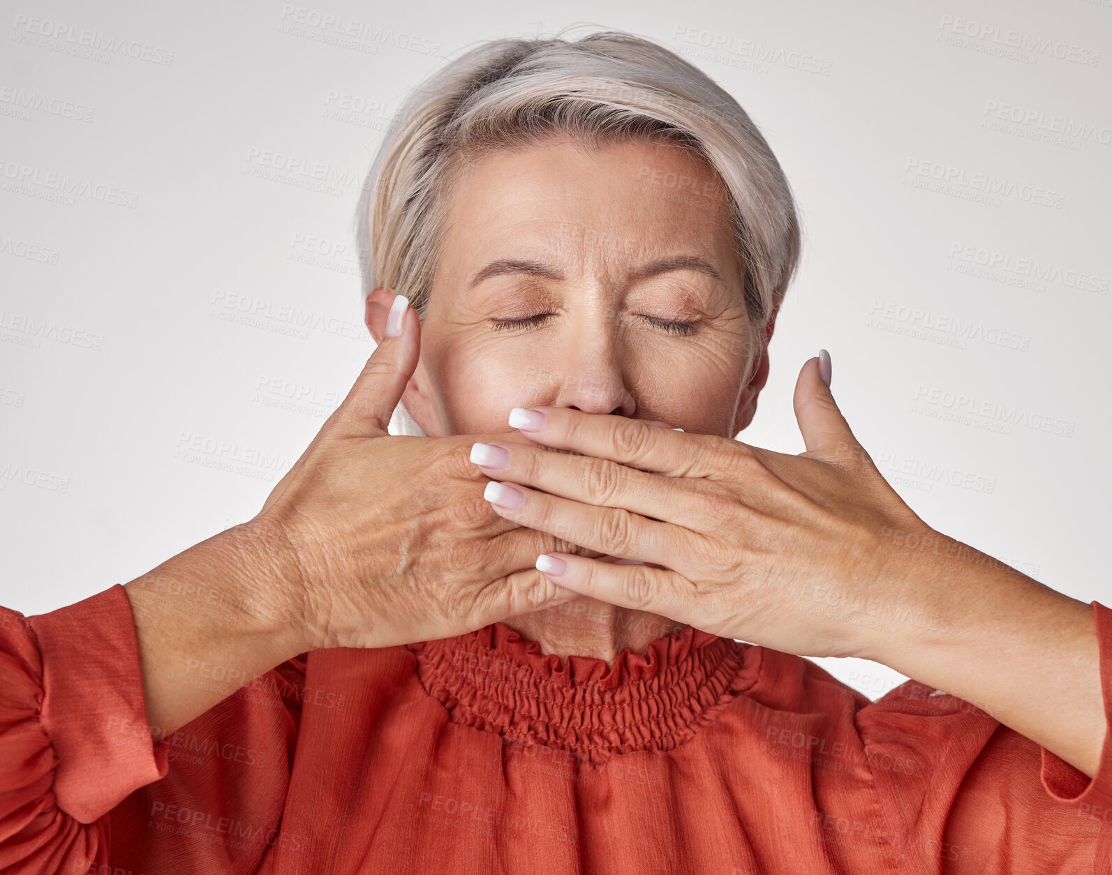 Buy stock photo Senior, hands and mouth of an elderly woman covering her teeth or lips with hand against a grey studio background. Mature and aging woman keeping secrets, not talking and hiding the truth or gossip.