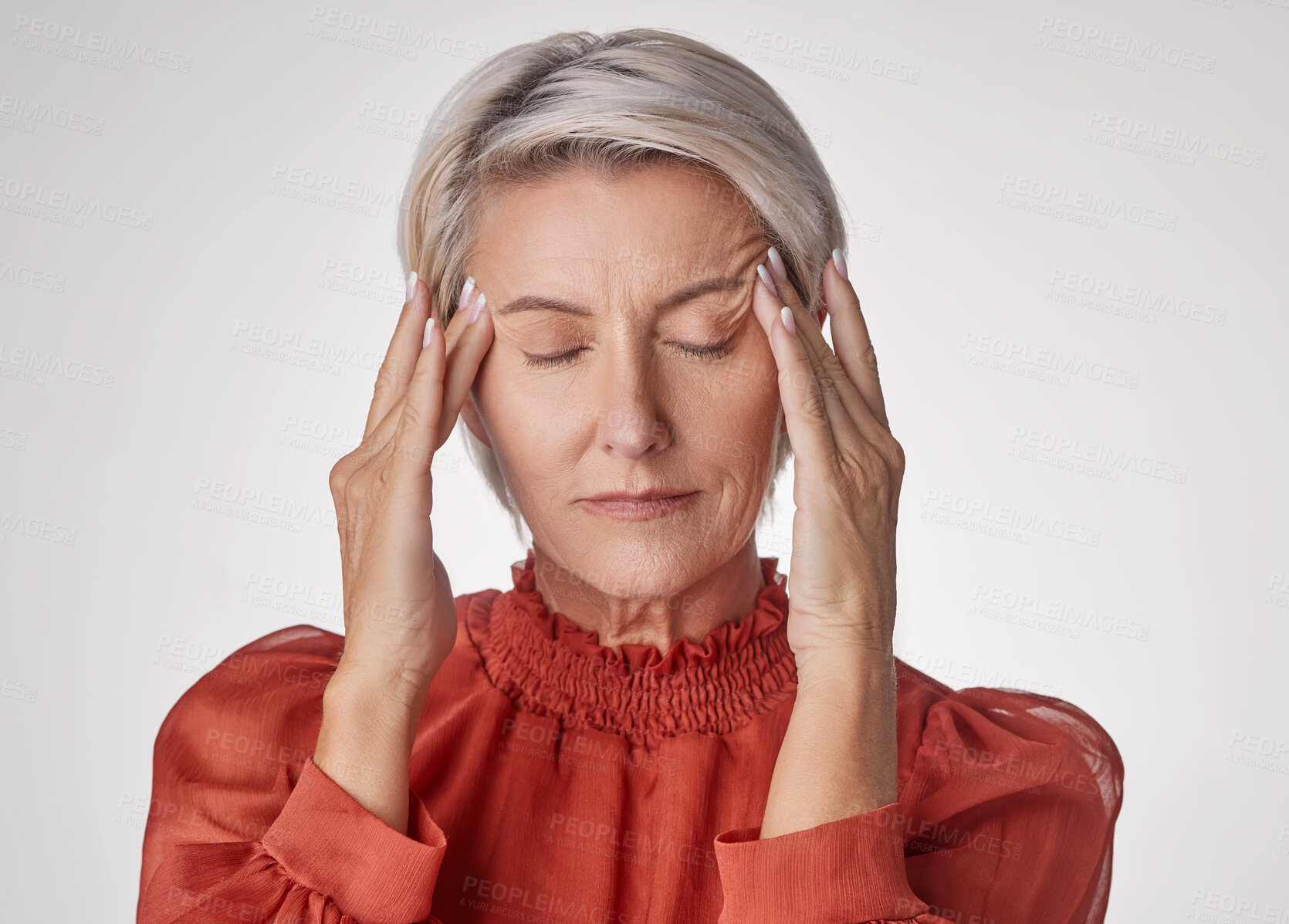 Buy stock photo One mature woman suffering with a headache and looking stressed while posing against a grey copyspace background. Ageing woman experiencing anxiety and fear in a studio