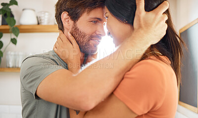Buy stock photo Young content interracial couple bonding staring into each other’s eyes at home. Loving caucasian boyfriend and mixed race girlfriend standing in the kitchen. Husband and wife relaxing and spending time together in the morning