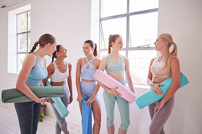 Buy stock photo Friends talking before yoga class. Young women standing a pilates studio. Dedicated friends bonding before yoga class. Women waiting before holistic yoga class. Happy friends talking in yoga class