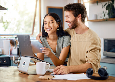 Buy stock photo Happy young interracial couple calculating their budget using wireless devices at home. Smiling young caucasian man working on laptop while hispanic wife browses social media on digital tablet