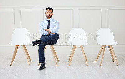 Buy stock photo Full length of asian businessman waiting for an interview. One young impatient applicant sitting alone. Ethnic professional with arms folded in line for job opening, vacancy and opportunity in office