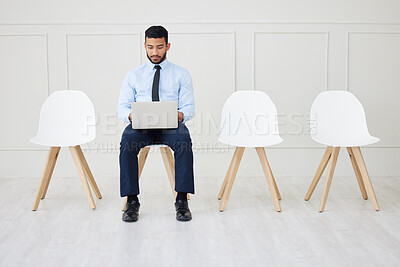 Fullbody asian businessman waiting for interview and using laptop. Applicant sitting alone, browsing internet on technology. Professional candidate in line for job opening, vacancy, office opportunity