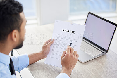 Buy stock photo .Above of unknown mixed race hiring manger reading resume and cv of candidate. CEO sitting alone and using laptop, paperwork for applicant looking for job opening, vacancy, office opportunity. Hr boss