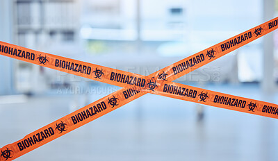 Closeup of biohazard tape blocking prohibited area. Caution tape is used as warning for quarantine hospital room. Toxic empty hospital room in pandemic. Orange security tape blocking hospital room