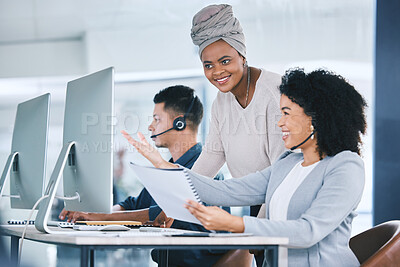 Buy stock photo African american call centre telemarketing agent training new mixed race assistant on a computer in an office. Team leader and supervisor troubleshooting solution with intern for customer service and sales support. Colleagues operating helpdesk together