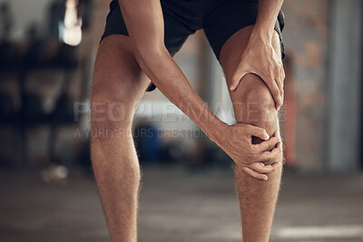 Buy stock photo Closeup of athlete knee joint pain. Hands of fit man touching his knee in pain. Strong man with a sore knee in the gym. Bodybuilder with a hurt knee injury. Active man with a knee sprain