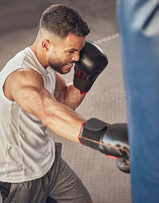 Buy stock photo Strong boxer hitting punching bag. Mma fighter wearing boxing gloves in combat training. Bodybuilder doing cardio training in the gym. Active boxer doing boxing practice in the gym.