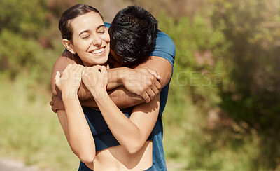 Affectionate young interracial couple taking a break from exercise and run outdoors. Loving man hugging arm around woman while motivating each other towards better health and fitness