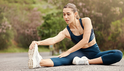 Buy stock photo One fit young mixed race woman touching her feet and stretching legs for warmup to prevent injury while exercising outdoors. Female athlete preparing body and muscles for training workout or run at the park