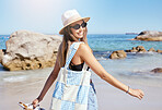 One beautiful young caucasian woman relaxing on the beach. Enjoying a summer vacation or holiday outdoors during summer. Taking time off and getting away from it all. Spending the day alone outside