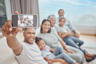 Buy stock photo Happy and affectionate young mixed race family of six taking a selfie at home. Married couple with their mother, father, son and daughter in the lounge. Taking a photograph with with grandparents