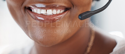 Closeup of one happy african american call centre telemarketing agent with big smile talking on headset while working in office. Face of confident friendly female consultant operating helpdesk for customer service and sales support