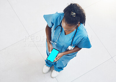 Buy stock photo Nurse, phone and green screen with mockup for black woman with healthcare, medical and wellness app. Top view, mobile technology and mock up for hospital worker with medicine help and insurance logo