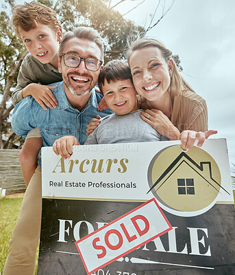 Portrait of happy caucasian family holding a sold sign while relocating and moving into a new house. Smiling parents and kids secure homeowner loan for property real estate and home purchase