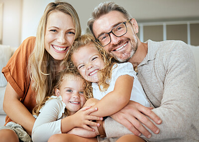 Buy stock photo Parents, portrait and sofa with hug, kids and smile with love, bonding and care in family home together. Father, mother and daughters with happiness, embrace and relax on lounge couch in house