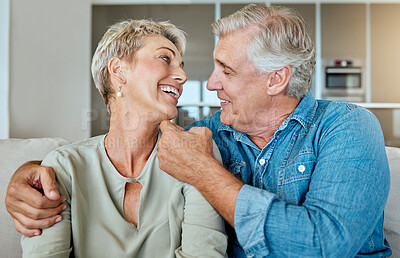 Buy stock photo A happy relaxed mature retired couple talking and laughing together in the living room. Smiling caucasian couple bonding on the sofa  at home