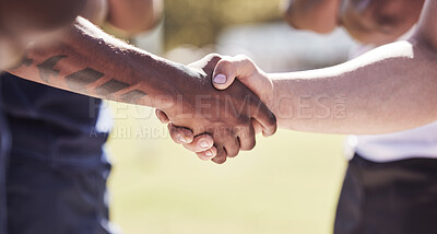Buy stock photo Closeup two opponent rugby teams shaking hands before or after a match outside on a field. Rugby players sharing a handshake to show respect and sportsmanship. A mutual understanding of the game