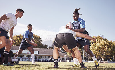 Buy stock photo Caucasian rugby player attempting to tackle an opponent during a rugby match outside on the field. Young athletic man tackling an opponent in an attempt to stop him from scoring. Last line of defense