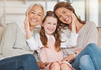 Buy stock photo Family generations of females sitting together and looking at the camera. Portrait of an adorable little girl bonding with her mother and grandmother at home. Enjoying a visit with her granddaughter