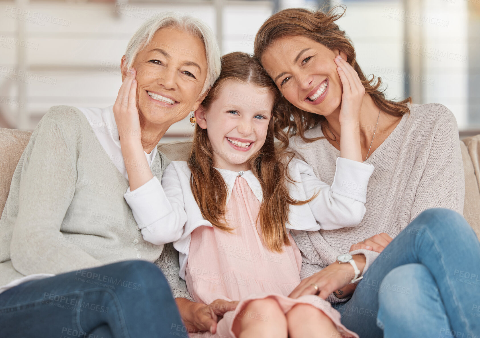 Buy stock photo Family generations of females sitting together and looking at the camera. Portrait of an adorable little girl bonding with her mother and grandmother at home. Enjoying a visit with her granddaughter