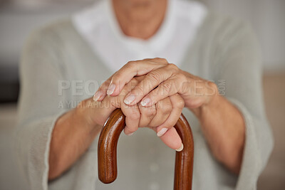 Buy stock photo Closeup of a seniors hands, disabled woman holding a cane in a nursing home. An elderly lady needing a walking aid or support, a crutch to lean on after having a stroke at an assisted living facility