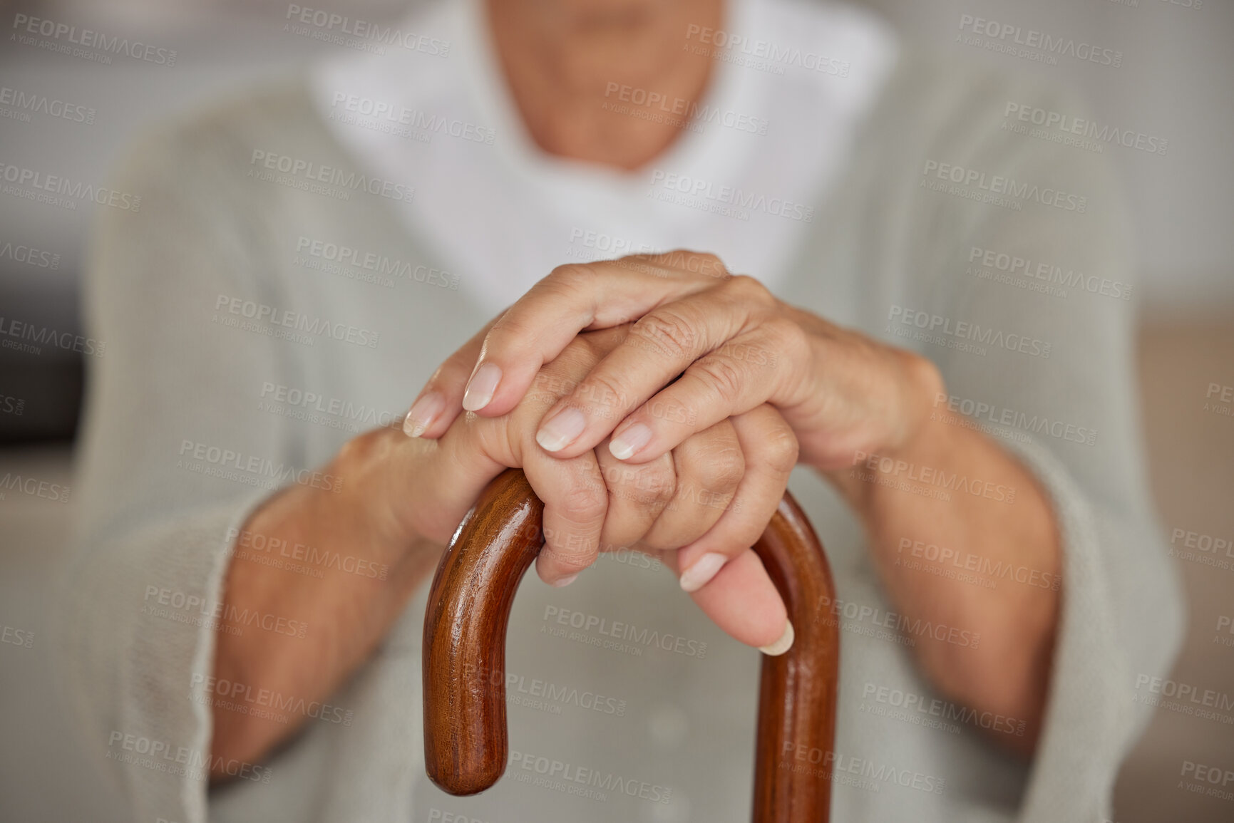 Buy stock photo Closeup of a seniors hands, disabled woman holding a cane in a nursing home. An elderly lady needing a walking aid or support, a crutch to lean on after having a stroke at an assisted living facility