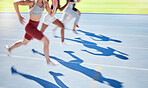 Athletes in motion running down a race track competing in an athletics event. Closeup of runners racing each other to the finish line. People running a marathon on a sunny day next to a sports field. 