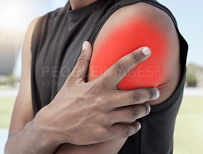 Closeup of african american sportsman suffering from inflamed shoulder injury. Zoomed in on unknown black man holding and rubbing sore arm with glowing red cgi. Overworking muscles causing tension