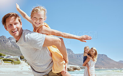 Buy stock photo Smiling family with daughters on the beach. Happy man and woman bonding with young adorable girls on holiday. Cute siblings pretending to fly while being carried by their mother and father outside